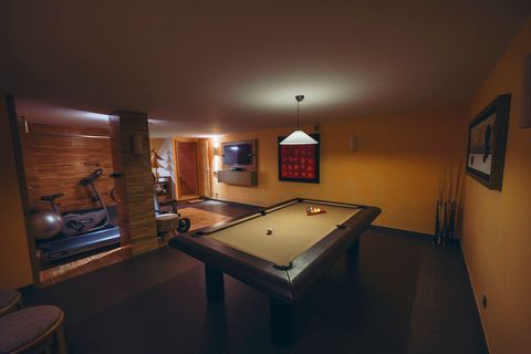 The billiards table with the gym visible through the opening beyond.
