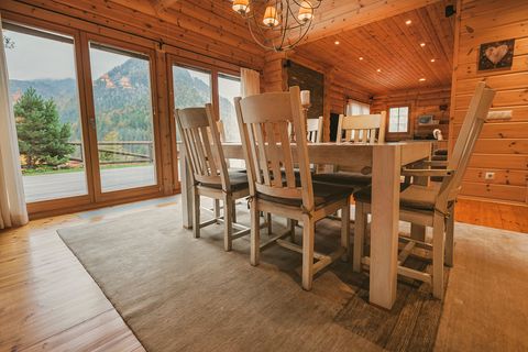 The dining table beside floor-to-ceiling windows, with mountain views visible outside.